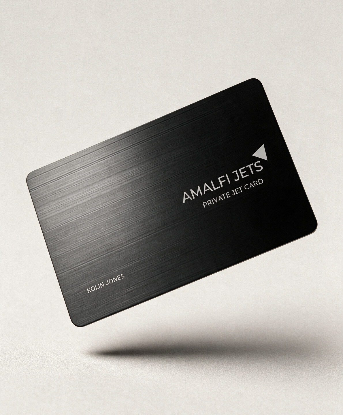 The black Amalfi Jets private jet card floating above an off-white surface.