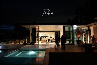 Elegant Amalfi Reserve dinner menu resting under a white plate at a private Amalfi Jets luxury member dinner.