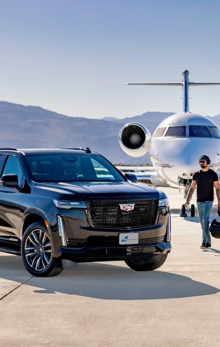 A black SUV waiting on the tarmac beside a private jet as a passenger walks over.