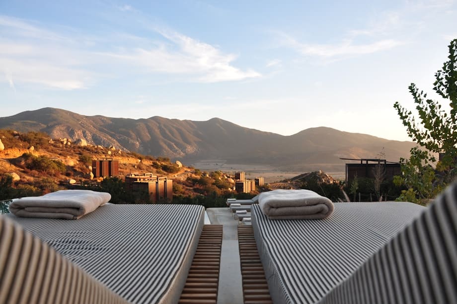 Private resort lounge chairs overlooking a peaceful mountain landscape