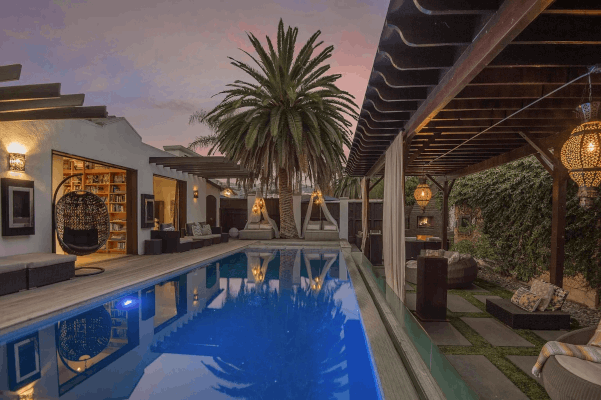 Blue pool in a dimly lit boho style tropical private villa